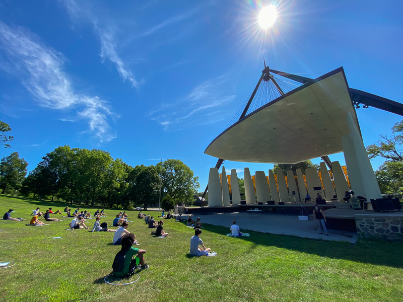 Students sitting in hula hoops at Slayter Hill