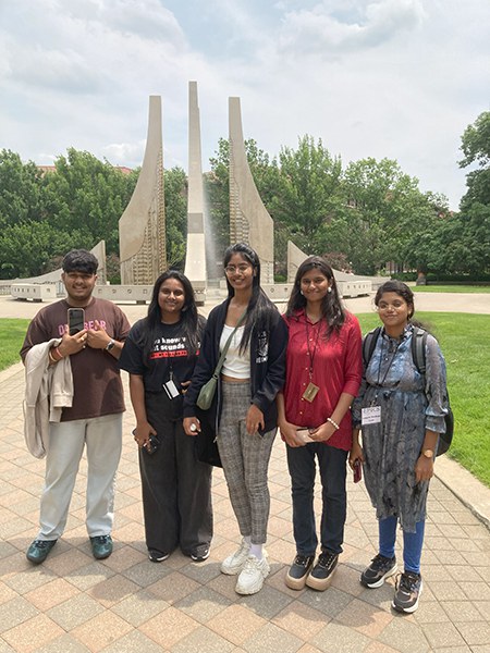 Five students standing in front of engineering fountain