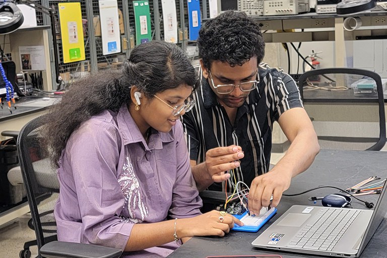 Two students working in a lab