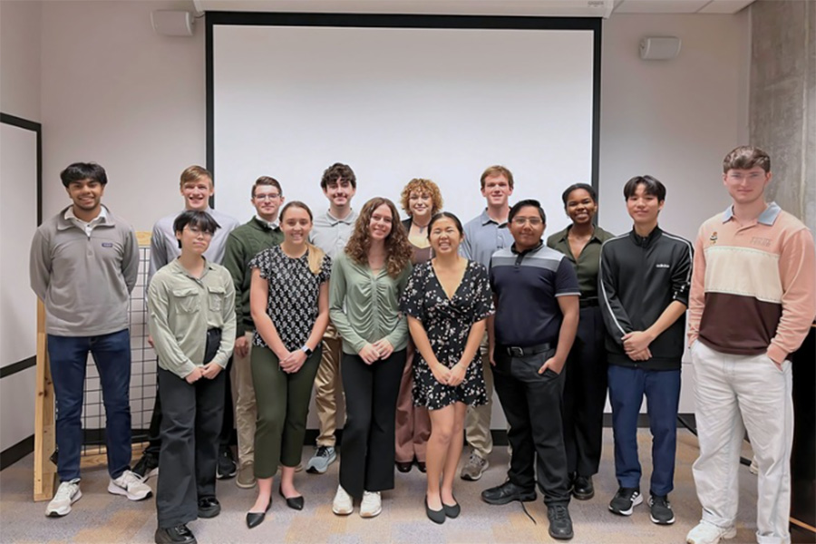 Group of students in a classroom in front of a projector screen