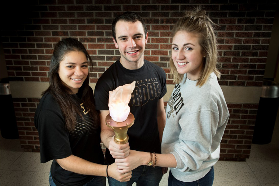 Students holding EPICS torch project