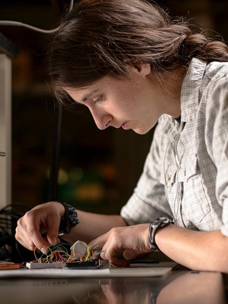 Student working on a circuit board