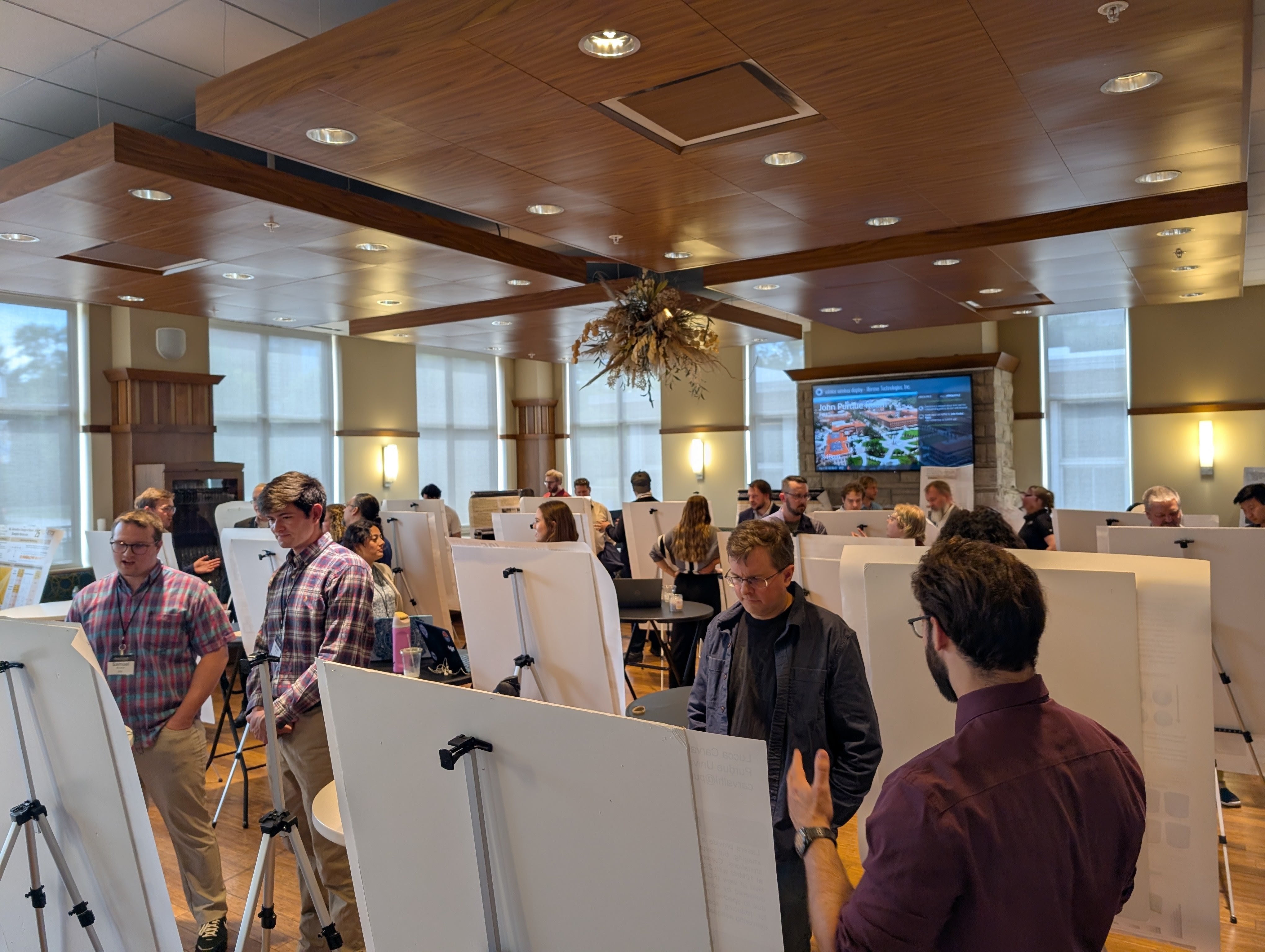 Students review posters in a poster session.