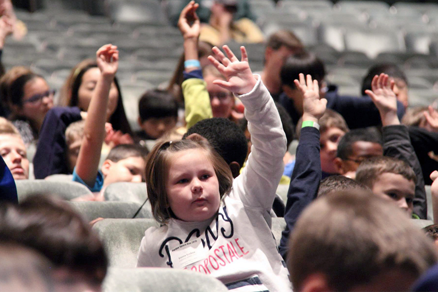 Kids with hands raised