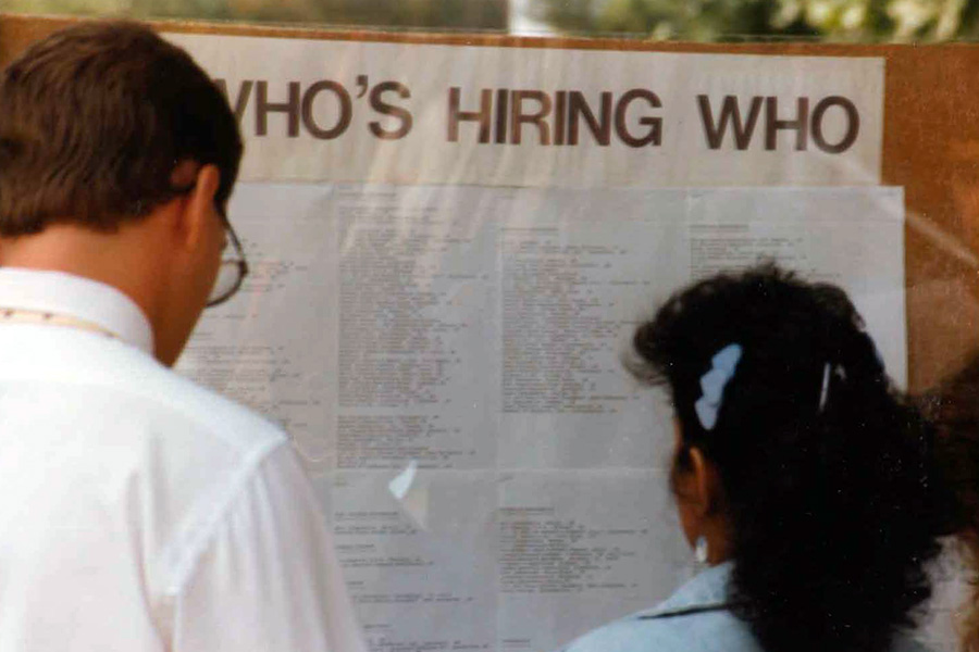 Students viewing bulletin board with job opportunities