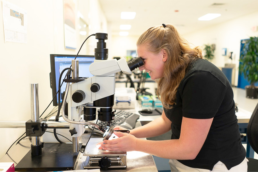 Student working at a microscope