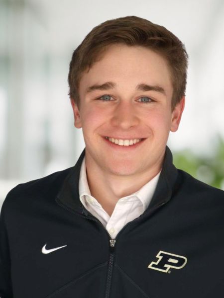 A portrait-style photo of Evan Dzurik in a black shirt with a Purdue Motion P.