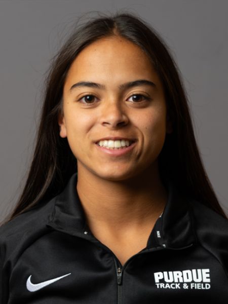 Headshot of Melissa Riegle, Purdue University electrical engineering student and varsity pole vaulter, smiling in a black Purdue Track & Field Nike quarter-zip jacket against a gray studio background.