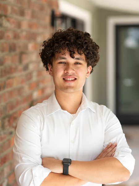 Carl Russell III, PhD/MD student in Purdue's Weldon School of Biomedical Engineering, smiles outdoors.