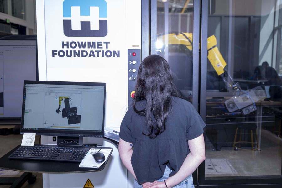 Kylea Hughes watches a ZEISS ScanBox robot arm capture a 3D scan in Purdue's Build@Scale Lab.