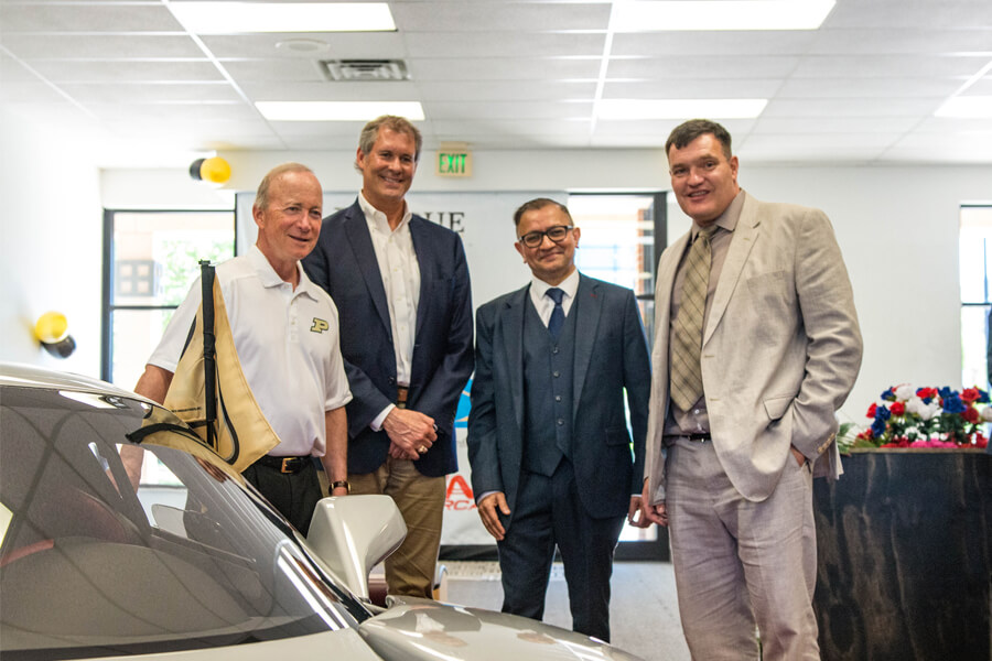 Purdue President Mitch Daniels, West Lafayette’s Mayor John Dennis, University of Bolton Provost Zubair Hanslot, and Tony Keating, CEO of Keating Supercars