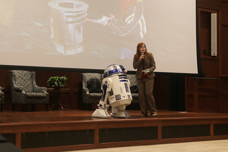 Freshmen Electrical Engineering student Alexandra Forsythe gives a presentation over the fully operational R2D2 she constructed.