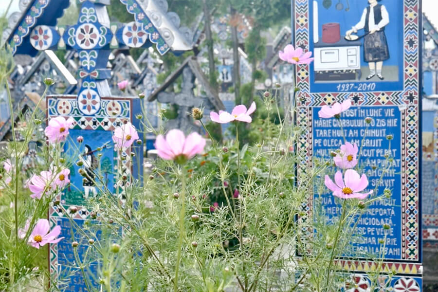 The Merry Cemetery of Maramures with colorful grave markers engraved with poems.