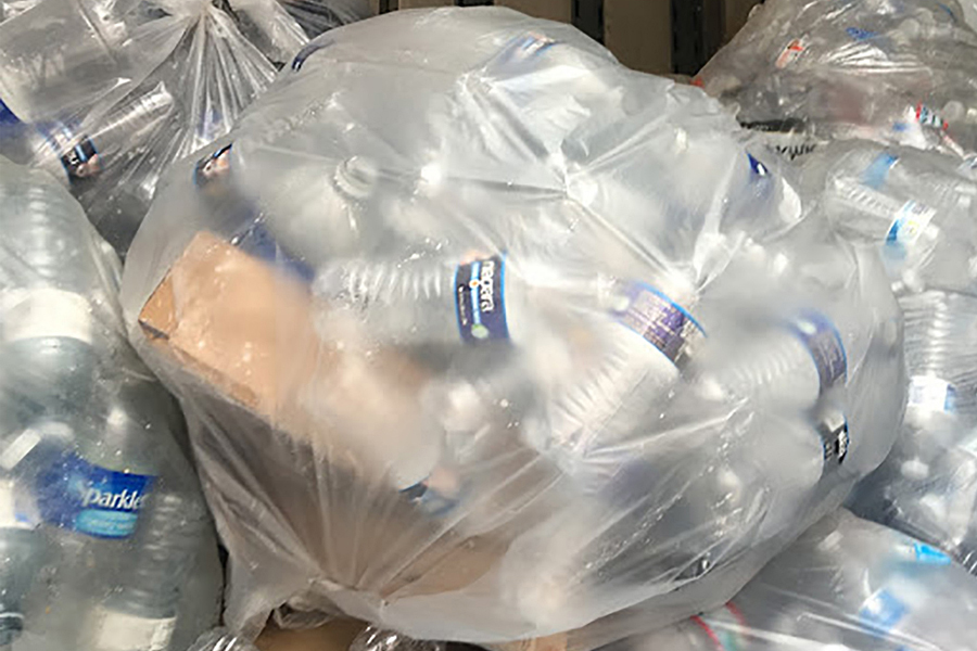 A pile of bags filled with empty plastic water bottles.