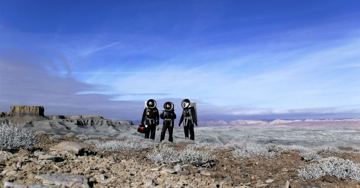 MDRS Mission 202 team members stand at the edge of an area called 