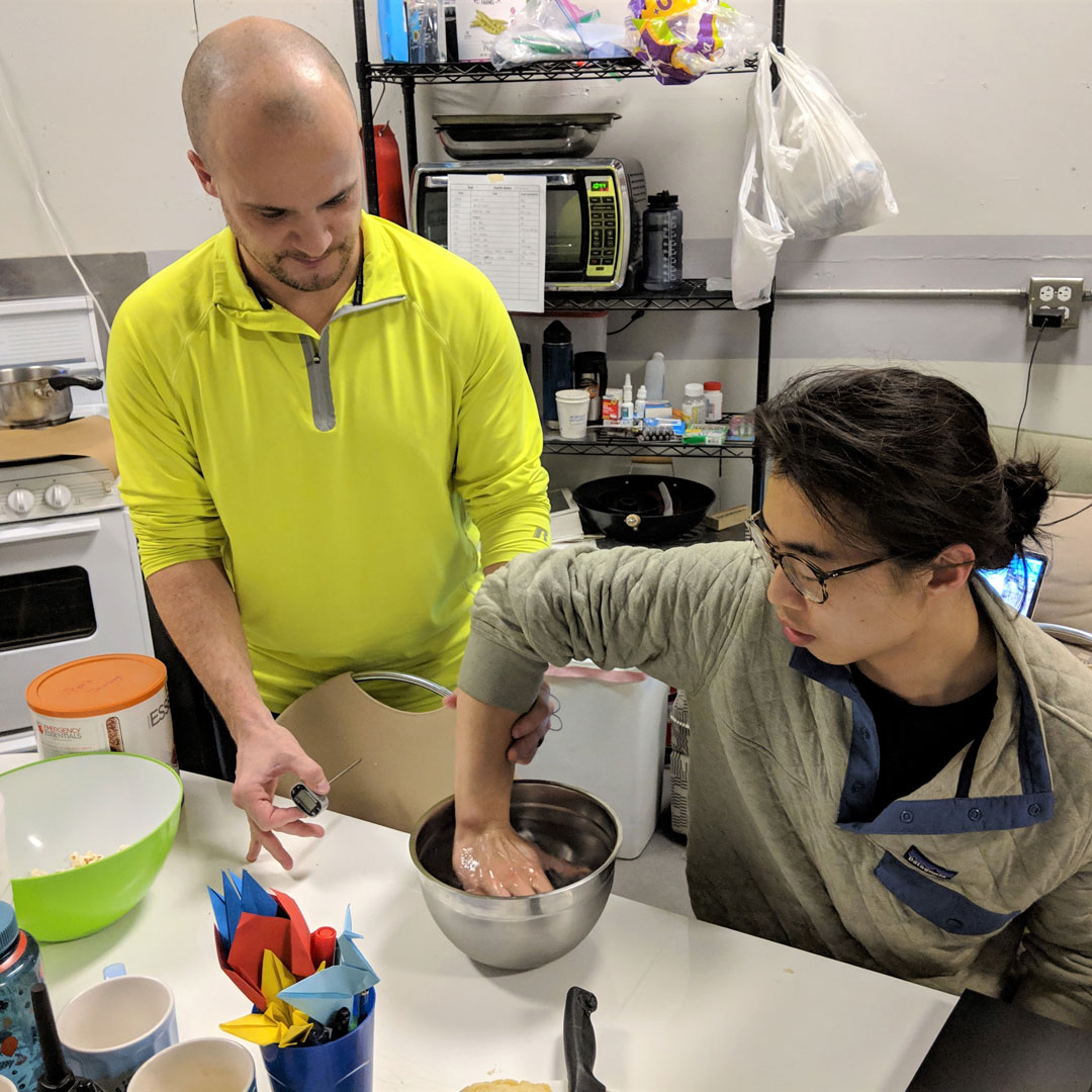 Denys Bolihov, IE, Executive Officer, performs a stress test on Jake Qiu, ABE, for his research on how stress affects the amount of risk the crew is willing to accept when making decisions.