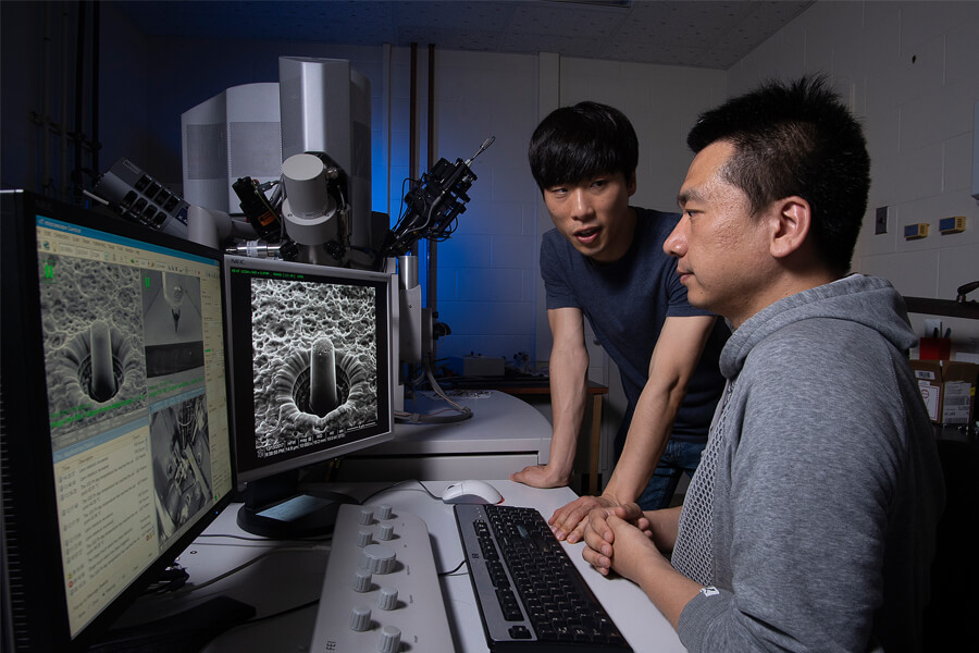 Purdue researchers observed for the first time how ceramics formed under an electric field surprisingly change shape rather than break when compressed at high strain. Pictured: Graduate research assistants Jaehun Cho and Qiang Li.