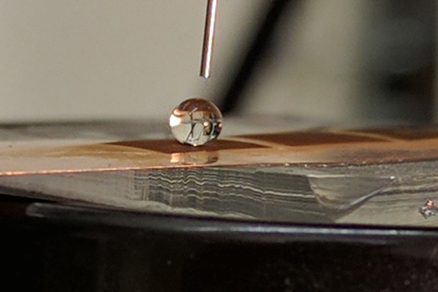 This image shows a water drop on a created superhydrophobic surface, showing a very high contact angle. Purdue University researchers developed a new manufacturing process to improve the water repellency for some common products.