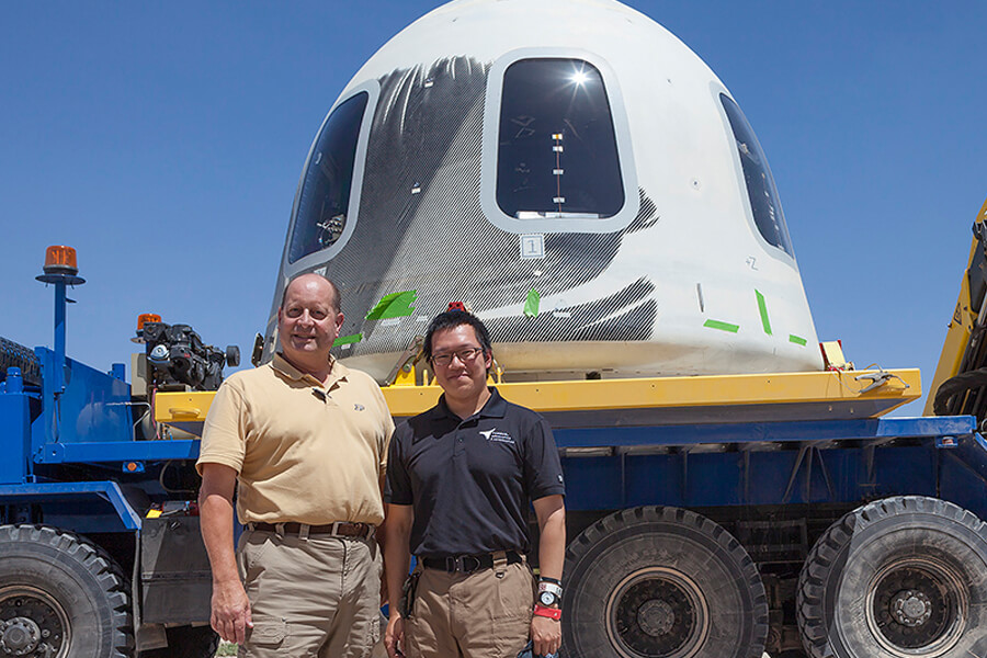 Steven Collicott, professor of aeronautics and astronautics at Purdue, and Shih-Pin 'Benny’ Cheng, an undergraduate student in Collicott’s Zero-Gravity Flight Experiment class, stand in front of the New Shepard crew capsule at the Blue Origin facility in Texas.