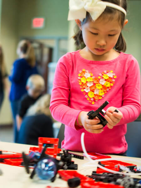 Children test out toys at the West Lafayette Library for the INSPIRE Research Institute for Pre-College Engineering’s annual Engineering Gift Guide.
