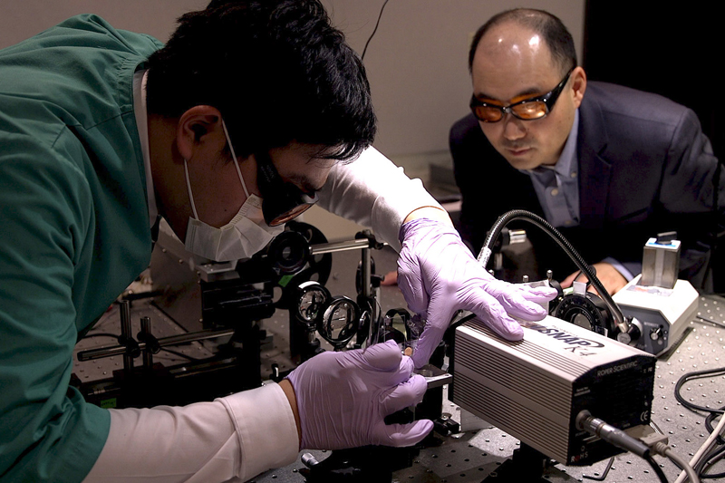 Purdue postdoctoral research associate Seung Ho Choi, at left, works with professor Young Kim to prepare a sample for analysis.