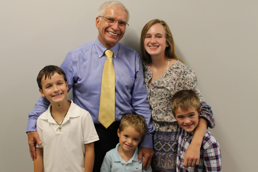 Stan Tebbe stands with grandchildren.