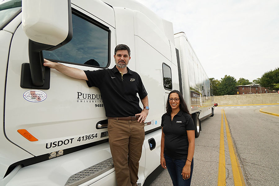 Photo of Shaver and Jain in front of truck