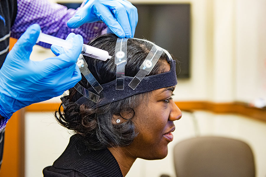 Photo of patient with electrodes attached to head