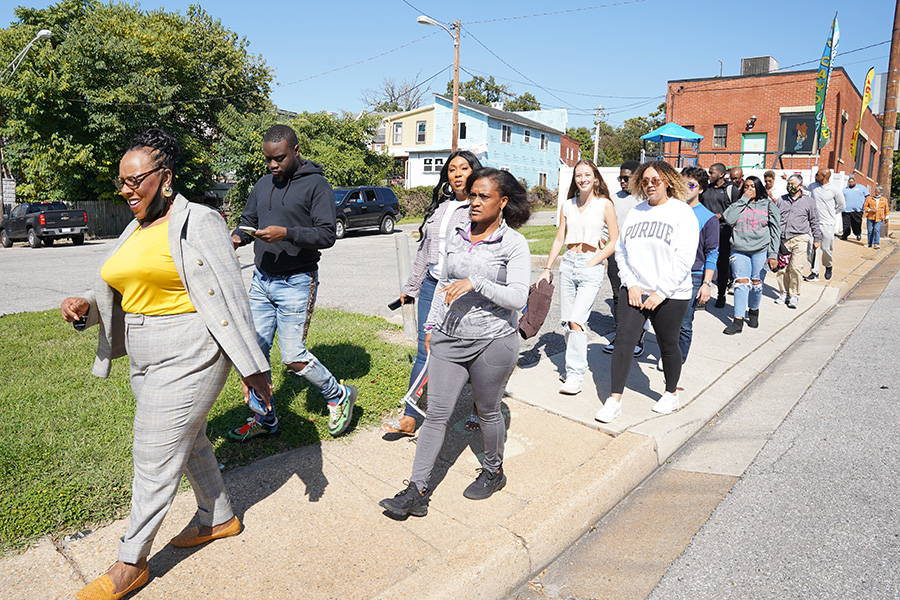 FYE students and Morgan State students and advisors walking in Baltimore neighborhood