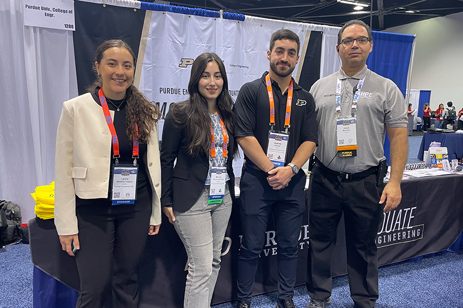 Purdue Graduate Engineering students, Laura Almeida Tinjaca, Marina Garcia, and Andres Gomez, engage with Purdue alum, Jesus Martinez, at the SHPE National Convention Career Fair