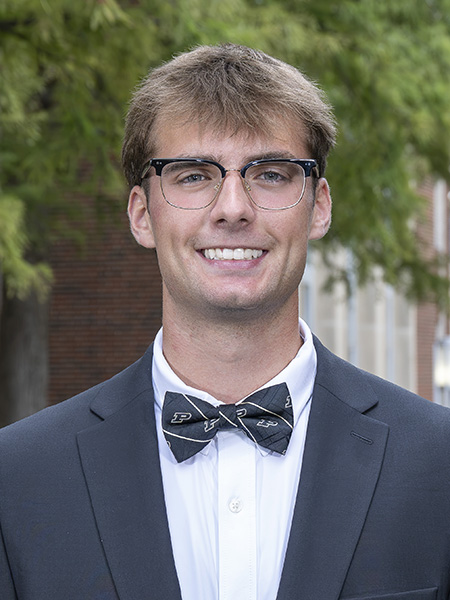 Student with light brown hair, wearing glasses and a bow tie