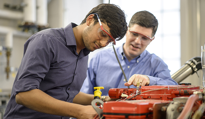 Two men working on an Engine