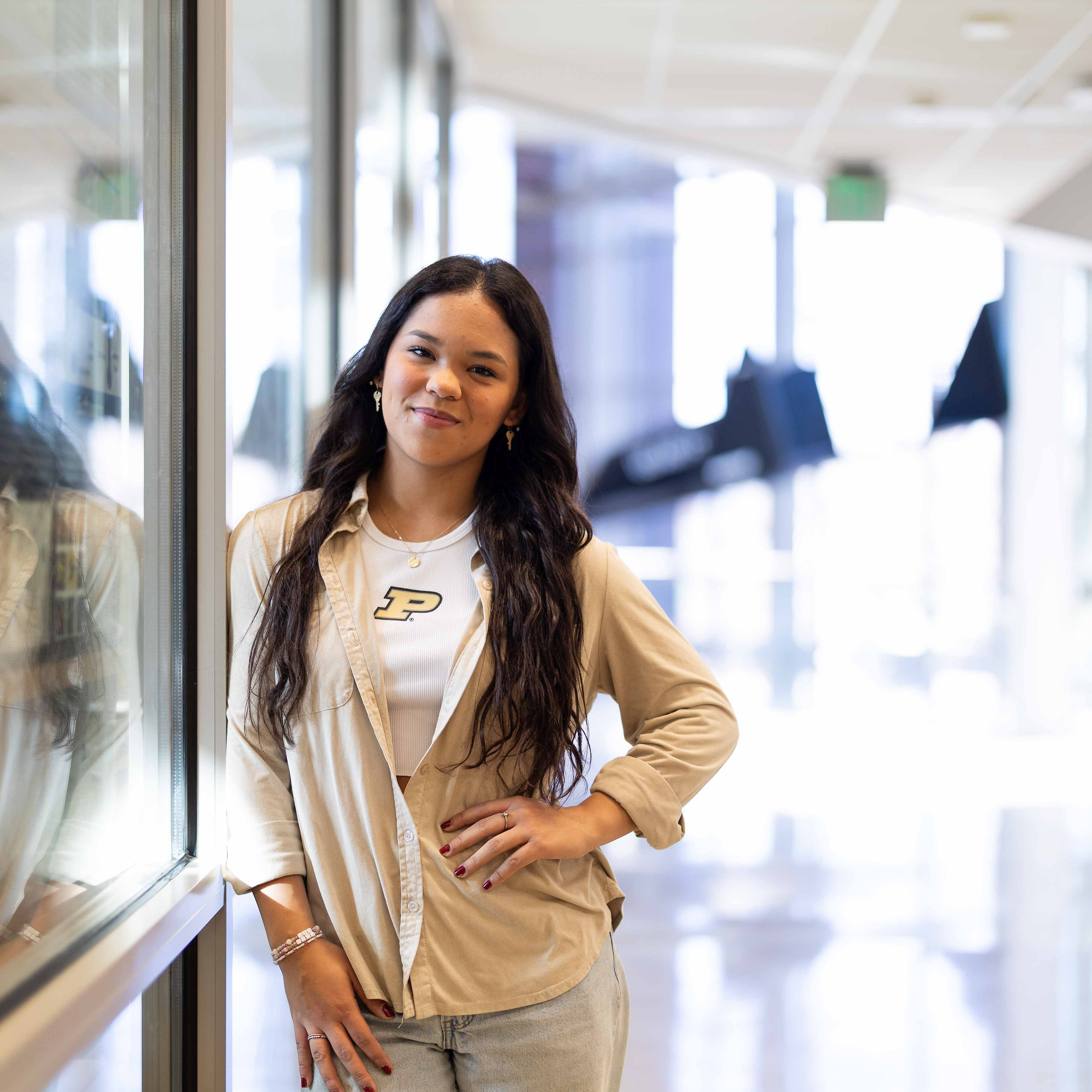Student with long dark hair wearing button up shirt