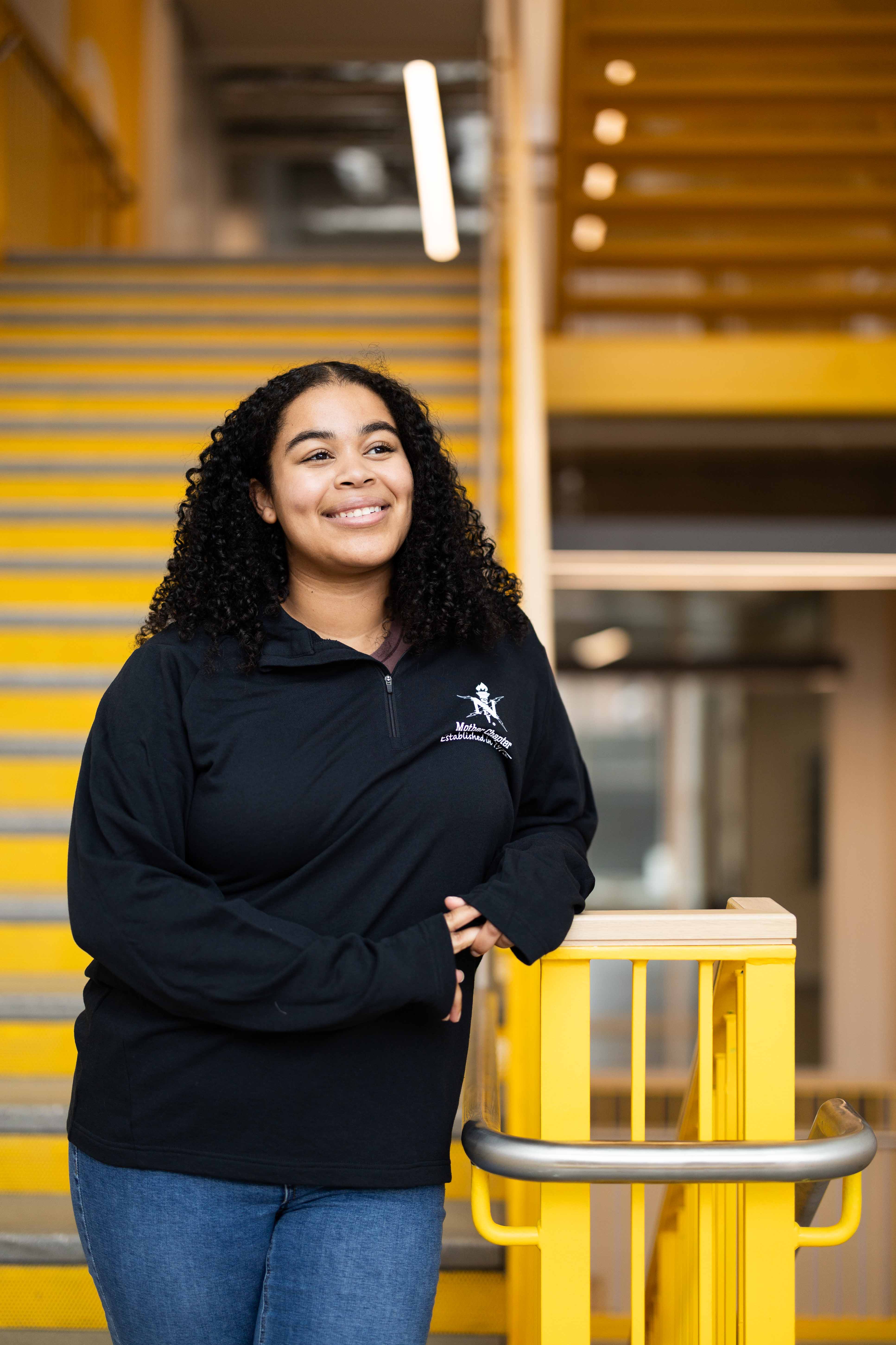 Student with dark curly hair
