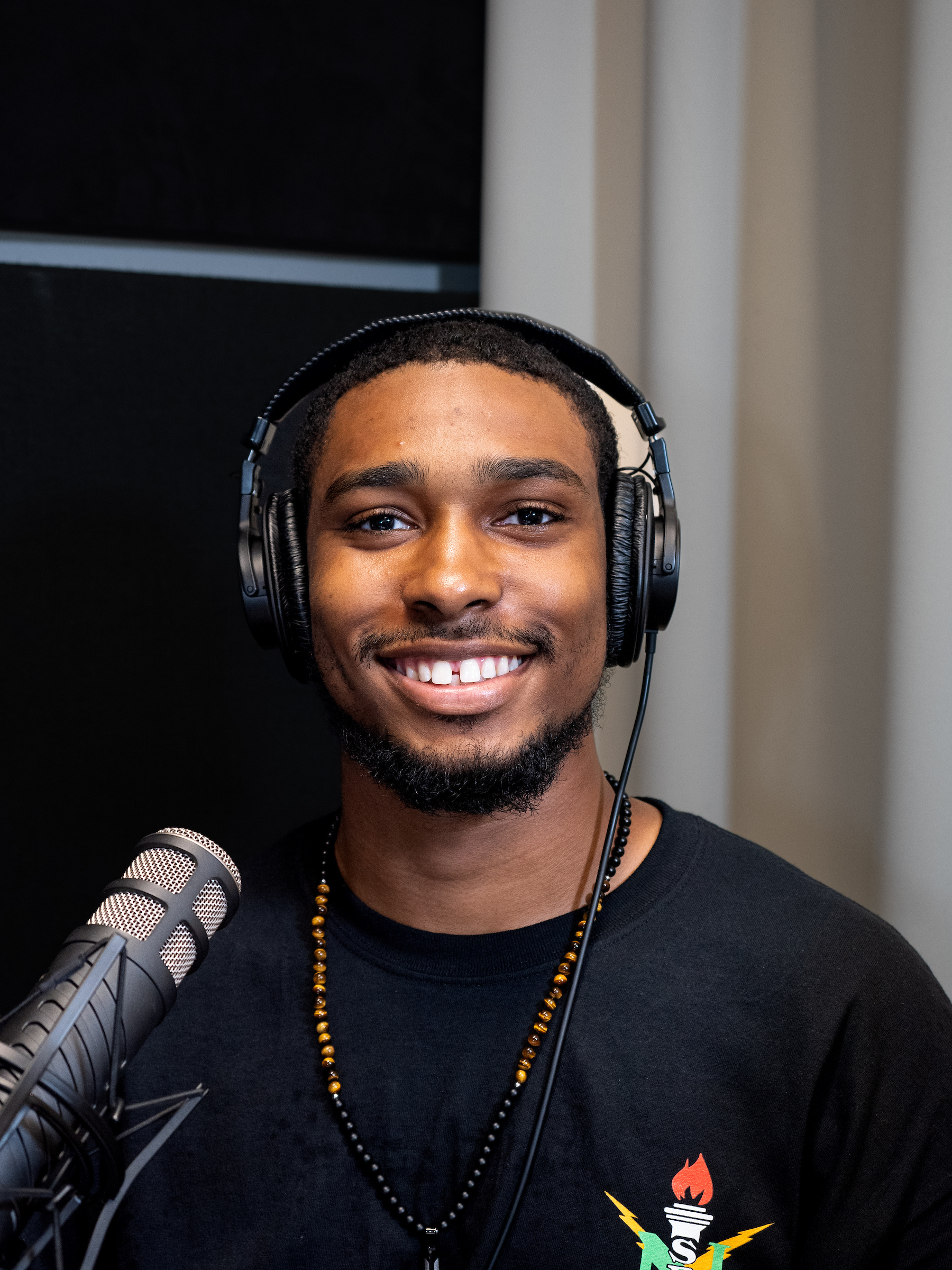 Man with dark hair, wearing headphones
