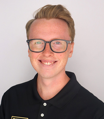Student with glasses and black polo