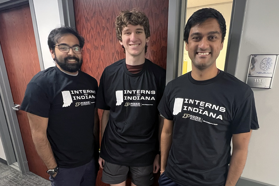 Three people wearing Interns for Indiana T-shirts
