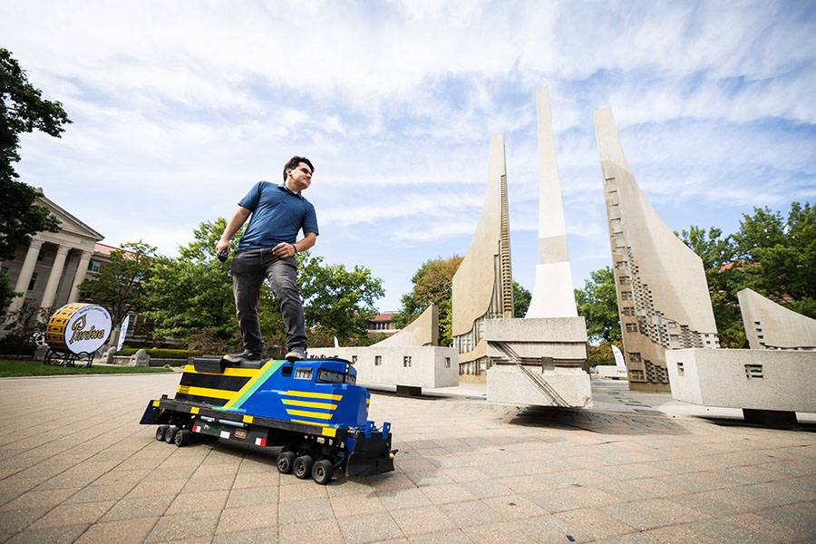 Student riding a locomotive skateboard