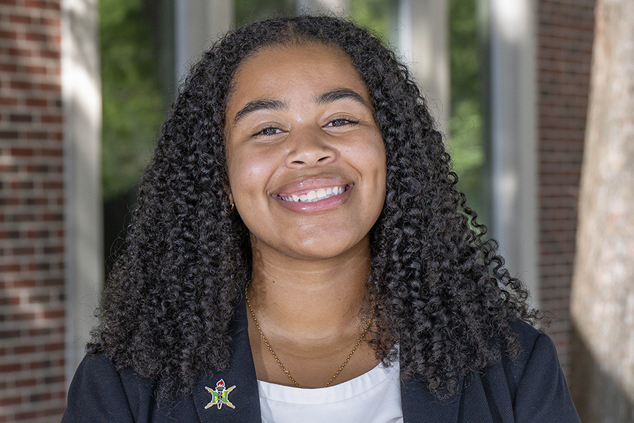 Amareah Bead smiling, black curly hair, black jacket