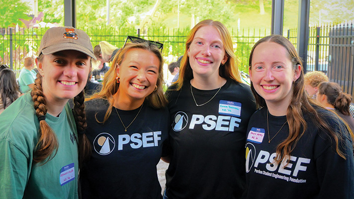 Kayla Manley poses with other current members and alum