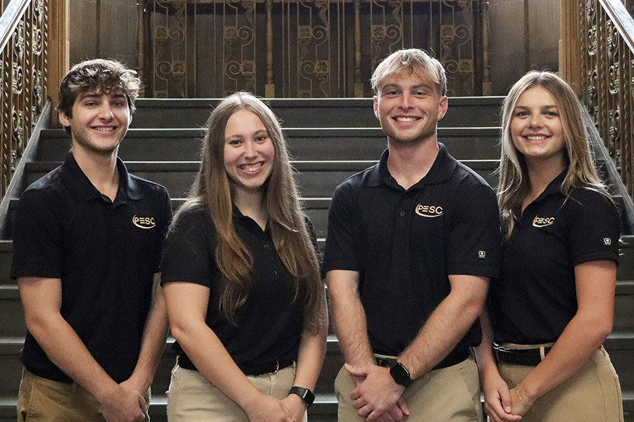 Four students standing on stairs in Purdue Memorial Union