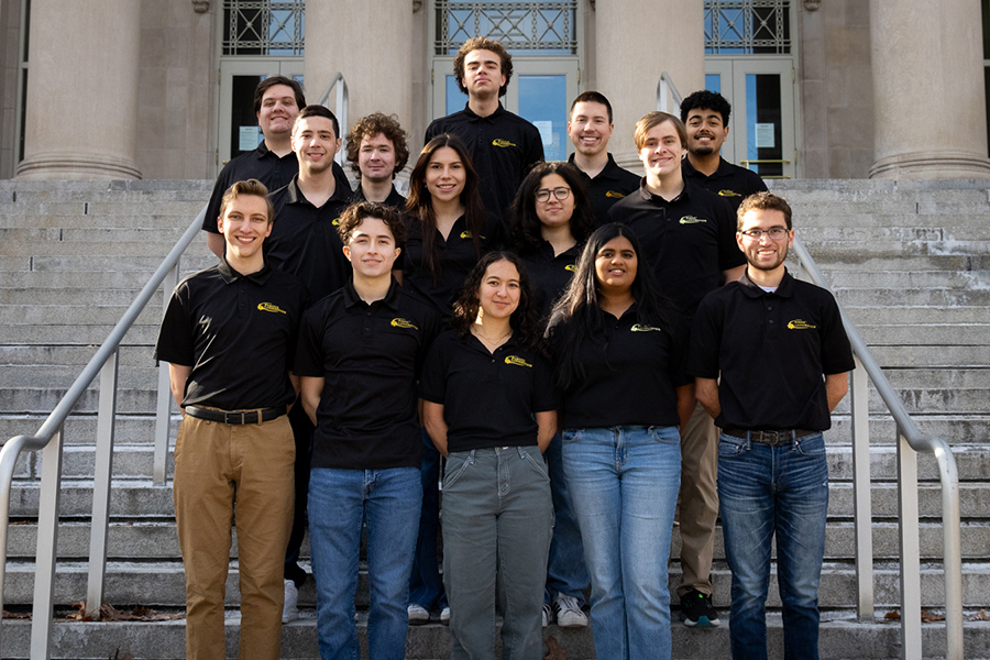 Group of students wearing black polos with Lunabotics logo on the chest