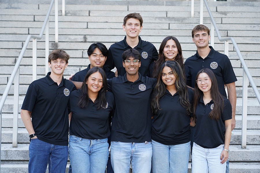 Group of students wearing matching black polo shirts with Purdue Mechanical Engineering Ambassadors logo on the chest