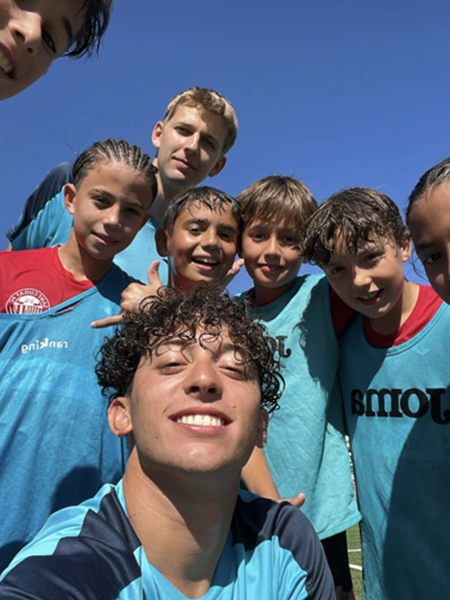 Ben Pekarek with members of the soccer team he coached