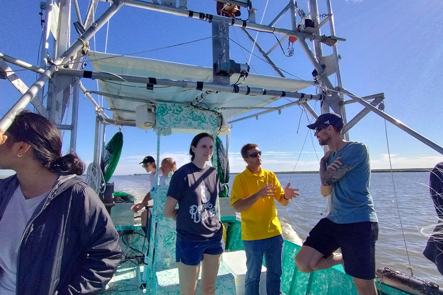 Jenna Carter on a boat with Bill Oakes in Louisiana