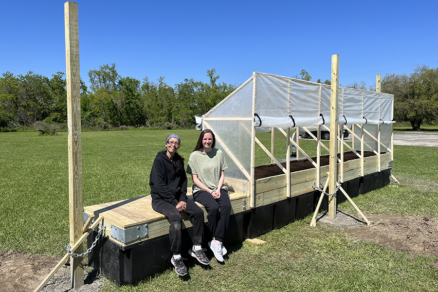 Jenna Carter standing next to floating garden
