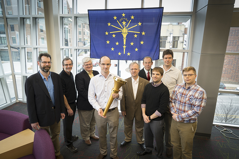 team members of the Bicentennial Torch Team posing with Indiana Flag and Torch