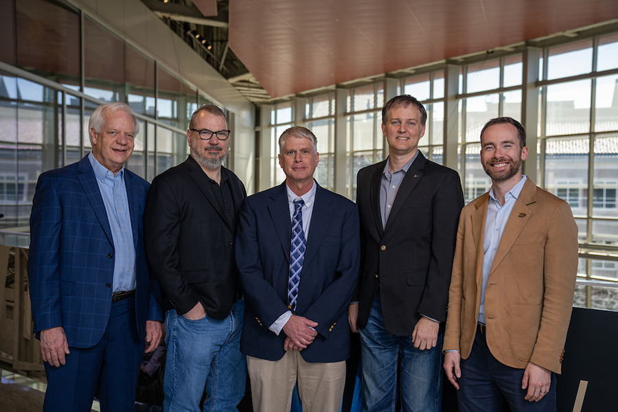 Sandhage, Krane, Johnson, Youngblood and Titus posing on the balcony of the Neil Armstrong Hall of Engineering