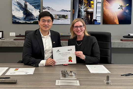 Purdue President Mung Chiang and Suzy Sterner, BWXT senior vice president and chief corporate affairs officer, holding signed agreement