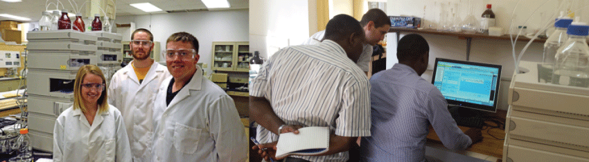 group of students in the lab looking at camera and computer